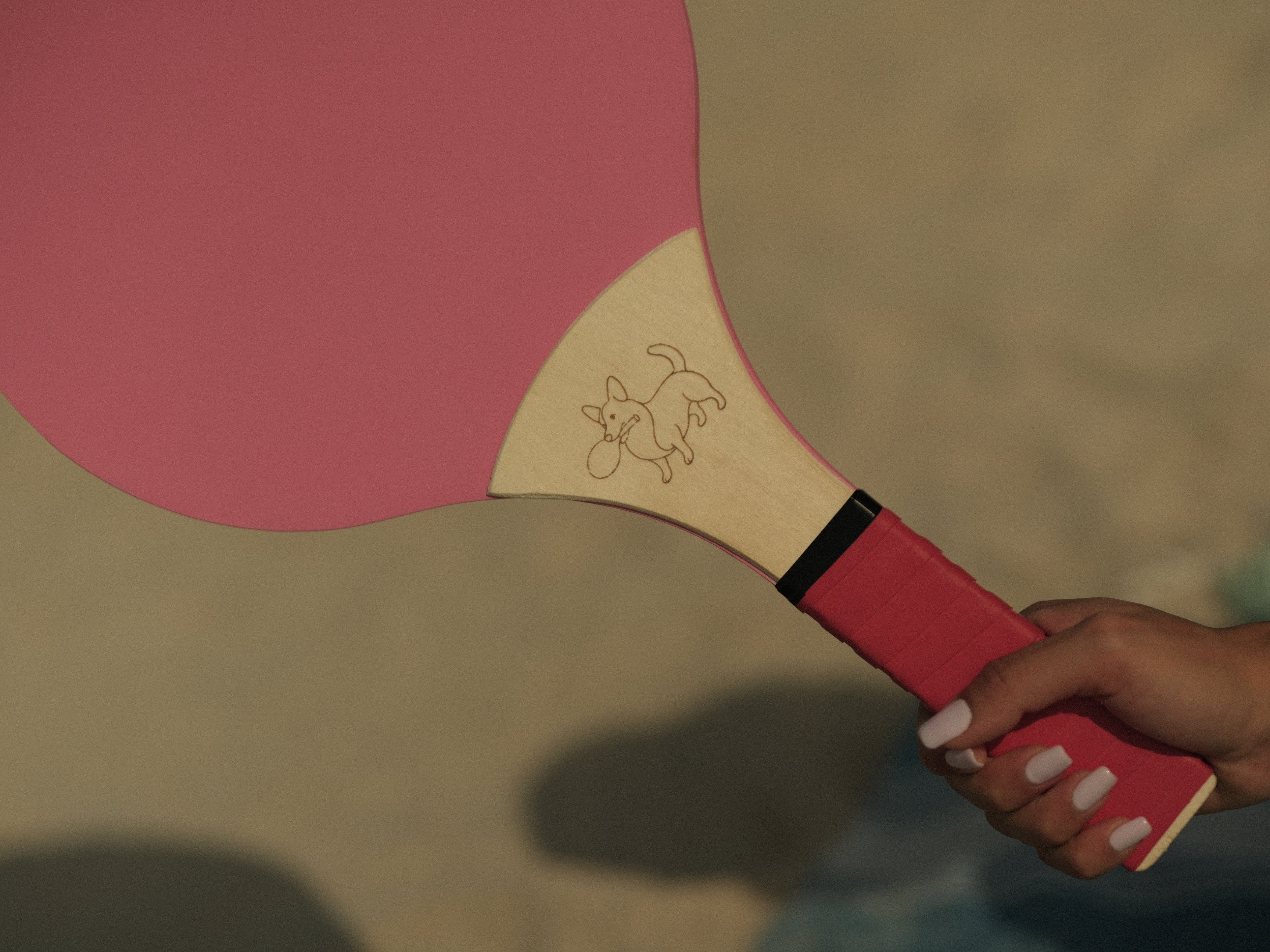 pink wooden racket with red grip comfy outdoor play 